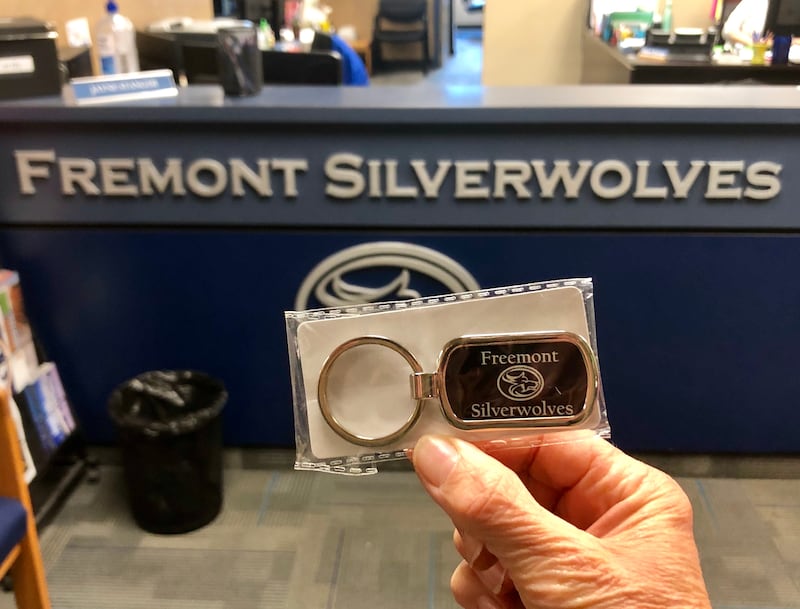 Fremont High School principal Michele Parry holds up a Freemont Silverwolves keychain.