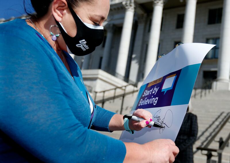 Rep. Angela Romero, D-Salt Lake City, signs a pledge to kick off Sexual Assault Awareness Month in April 2021.