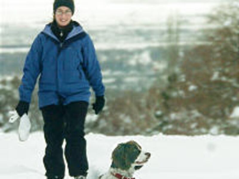 Andrea Dremann walks her dog Kinsey in snowshoes Monday at Bonneville Golf Course.