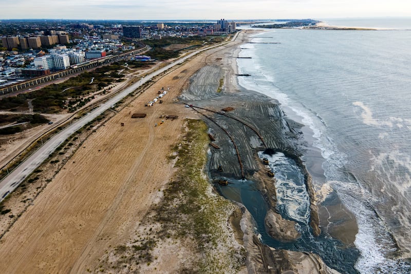 Contractors for the U.S. Army Corps of Engineers pump sand from the ocean floor onto the beach in the Rockaway Peninsula in New York City.