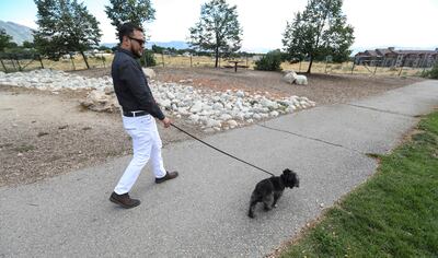 Daniel Torres is pictured with his dog at the Sandy Dog Park on Monday, July 29, 2019. Torres, who was undocumented when he served as a Marine in Iraq, has had a long road to obtain his U.S. citizenship.