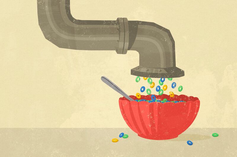 Cereal falls from an industrial pipe into a bowl with a spoon.