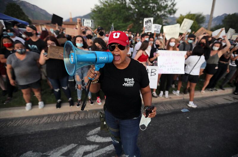 Lex Scott, founder of the Utah chapter of Black Lives Matter, is pictured with a bullhorn in Cottonwood Heights.