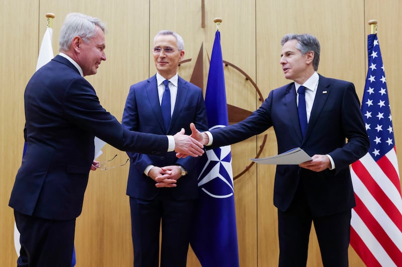 Finnish Foreign Minister Pekka Haavisto, left, shakes hands with U.S. Secretary of State Antony Blinken during a meeting at NATO headquarters in Brussels.
