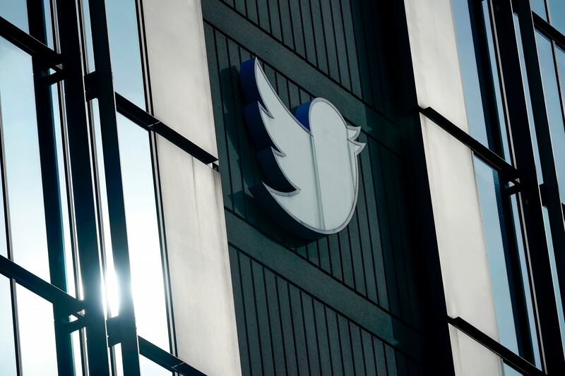 A Twitter logo hangs outside the company’s offices in San Francisco, Dec. 19, 2022.