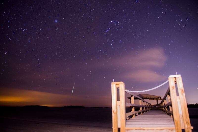 The Geminid meteor shower lights up the night sky above Tybee Island, Ga., early Thursday, Dec. 14, 2017.