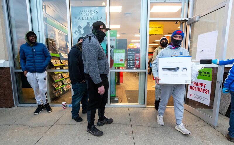 Ben Hoban, 17, of Clarks Summit, Pa., carries his new Sony PlayStation 5 video game console out of a GameStop store on Black Friday, in Dickson City, Pa. Friday, Nov. 27, 2020.