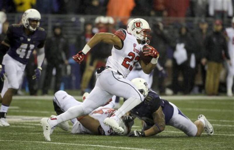 Utah running back Devontae Booker (23) runs against Washington during the first half of an NCAA college football game, Saturday, Nov. 7, 2015, in Seattle. (AP Photo/Ted S. Warren)