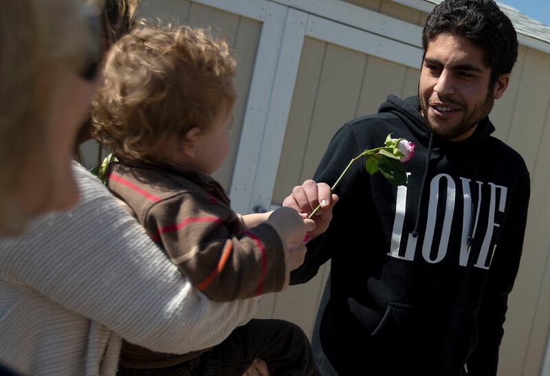 Community members hand flowers to worshippers at Al Sahaba Mosque in Orem after a prayer service on Friday, March 15, 2019. At least 49 people were killed in mass shootings at two mosques in New Zealand on Friday.