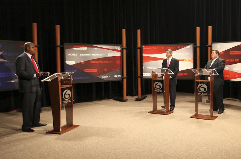 In this photo provided by the Nungesser Campaign, incumbent Louisiana Lt. Gov. Jay Dardenne, center, participates in a debate with challenger, Plaquemines Parish President Billy Nungesser, with host Norman Robinson, left, at the WDSU television studio in