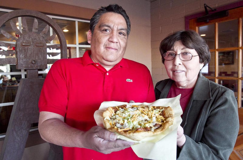 Michael Perry and Cecelia Miller stand with a fry bread at Fry Bread House in Phoenix on March 13, 2012. Their restaurant just won a James Beard Award. They first started serving fry bread in 1992.