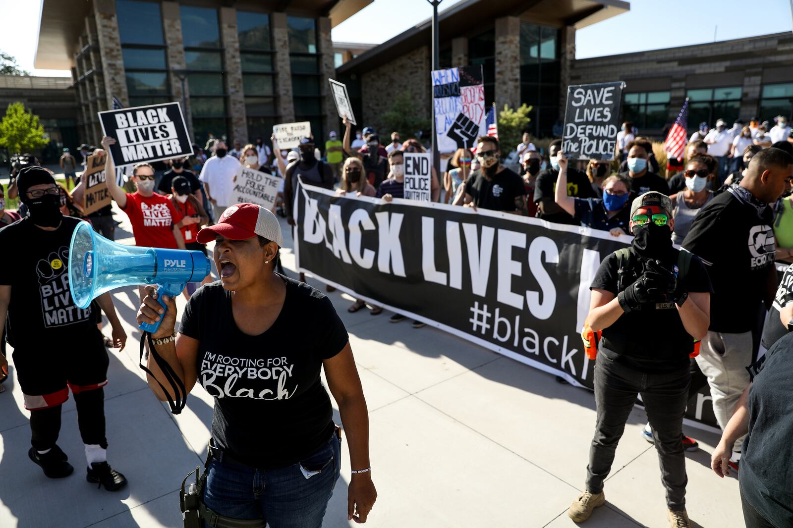 Lex Scott, founder of Black Lives Matter Utah, leads a chant as the organization holds a protest outside the Cottonwood Heights police department.