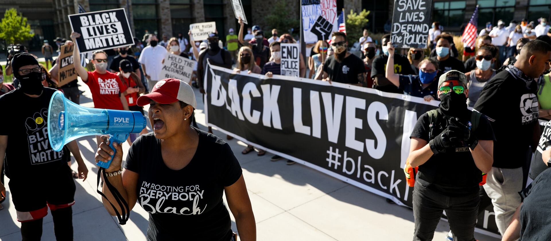 Lex Scott, founder of Black Lives Matter Utah, leads a chant as the organization holds a protest outside the Cottonwood Heights police department.