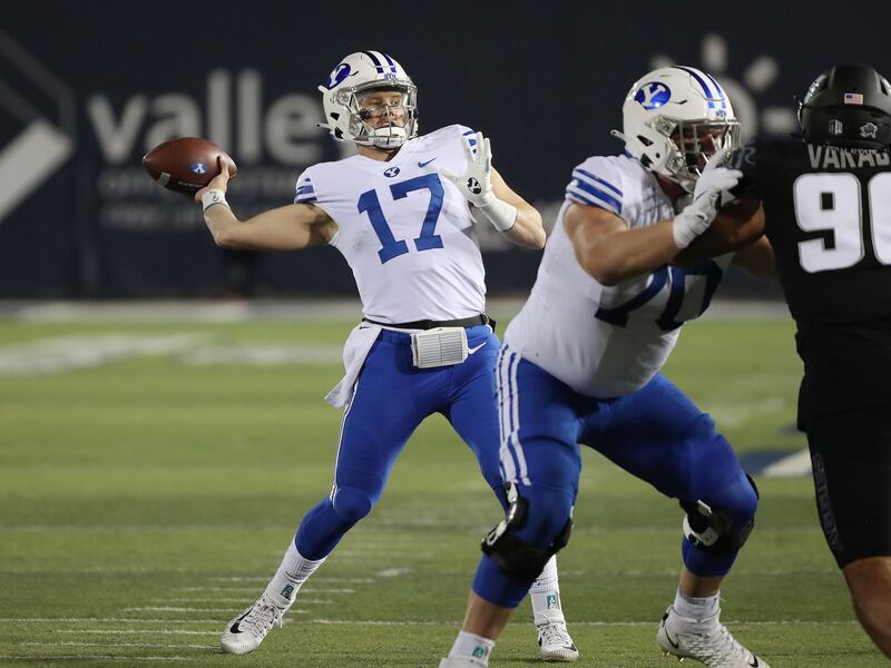 BYU quarterback Jacob Conover (17) throws against the Utah State Aggies.