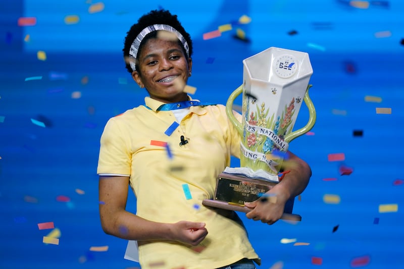 Zaila Avant-garde celebrates with the championship trophy after winning the finals of the 2021 Scripps National Spelling Bee.