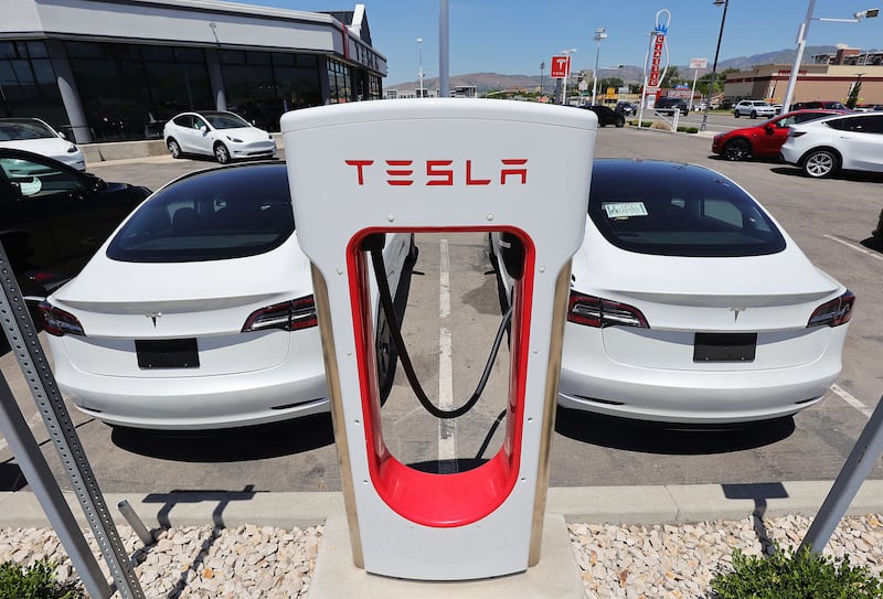Tesla electric cars charge at the Tesla dealership in Salt Lake City on June 4, 2021