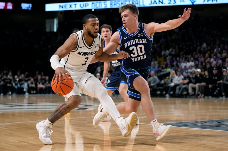 Central Florida guard Darius Johnson drives past BYU guard Dallin Hall during game, Saturday, Jan. 13, 2024, in Orlando, Fla.