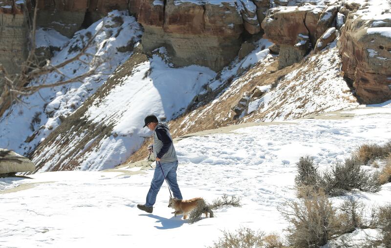 A man walks with his dog near Salt Wash in Emery County on Feb 23, 2019. The area has been designated as wilderness and for a new national monument under the Natural Resources Management Act.