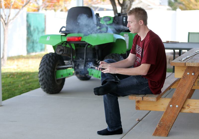 Brandon Vinson smokes outside his home in West Jordan on Thursday, Nov. 2, 2017. Vinson is in recovery from a heroin addiction.