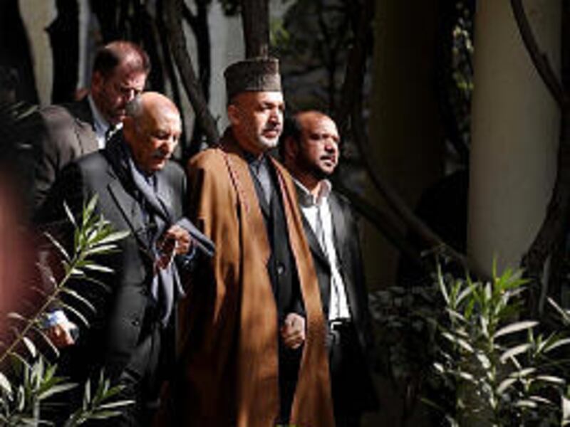 President Hamid Karzai, middle, former King Mohammed Zahir Shah, front left, and Deputy President Abdul Karim Khalili, right, attend presentation of a draft constitution.