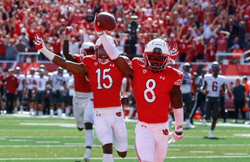 Utah cornerback Clark Phillips III and others celebrate a touchdown during game against Washington State in Salt Lake City.