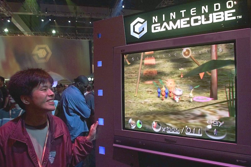 Tsutomu Hagiwara, director of Genki Co. Ltd., looks at Nintendo’s new game “Pikmin,” played on the new Nintendo GameCube console, at the Nintendo of America Inc. booth at the Electronic Entertainment Expo E3, the world’s largest video game trade show, Friday, May 18, 2001, at the Los Angeles Convention Center.