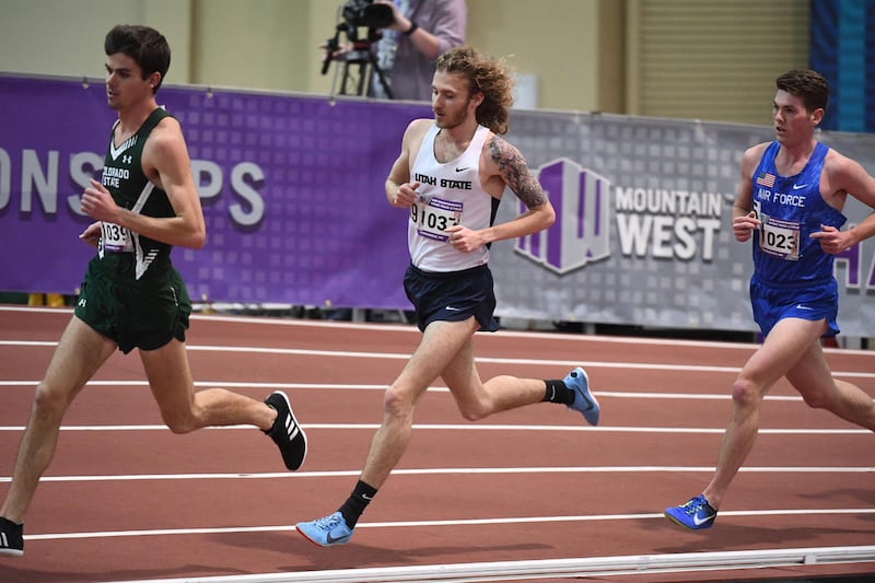Utah State senior distance runner Dillon Maggard (center) competes in the finals of the 5,000 meters at the Mountain West Indoor Track and Field Championships on Friday, Feb. 23.