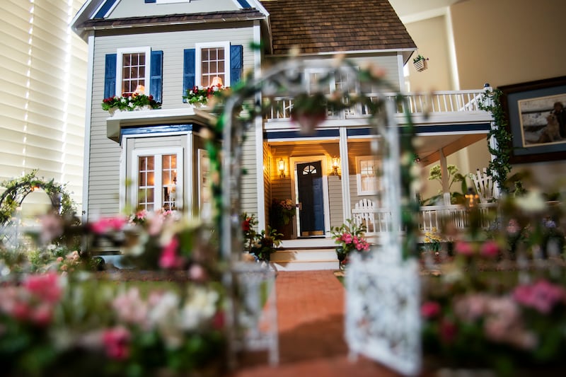 Larry Elkins shows a dollhouse he built matching the dream home he and his late wife Linda had planned to build as he talks about their life together and their family on Wednesday, March 27, 2019.