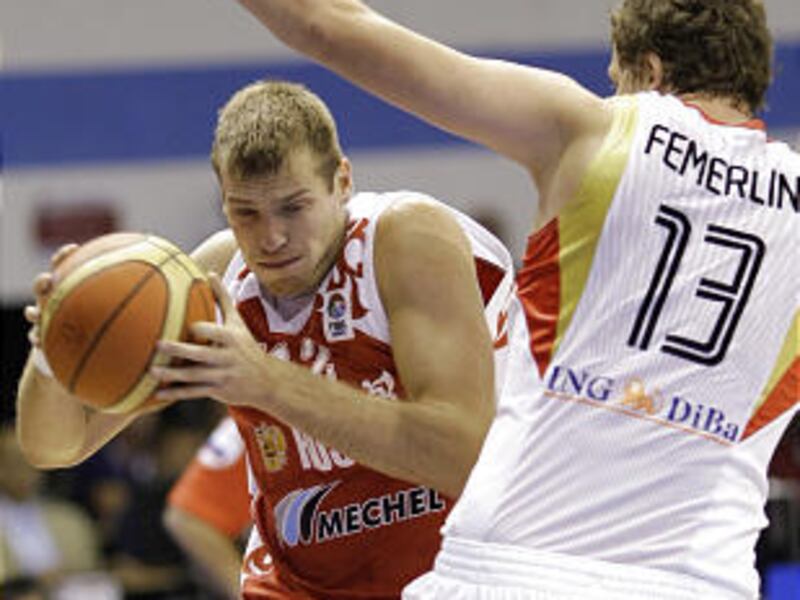 Russia's Sergey Monya, left, is challenged by Germany's Patrick Femerling during a EuroBasket 2009 European Basketball Championships group B match in Gdansk, northern Poland, Tuesday.