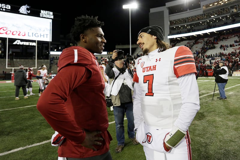 WSU quarterback Cameron Ward, left, and Utah quarterback Cameron Rising speak after game, Oct. 27, 2022, in Pullman, Wash.
