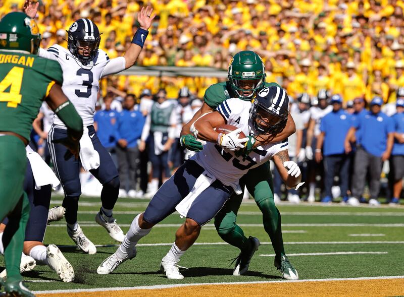BYU quarterback Jaren Hall celebrates as teammate Tyler Allgeier crosses the goal line to score a touchdown against Baylor.