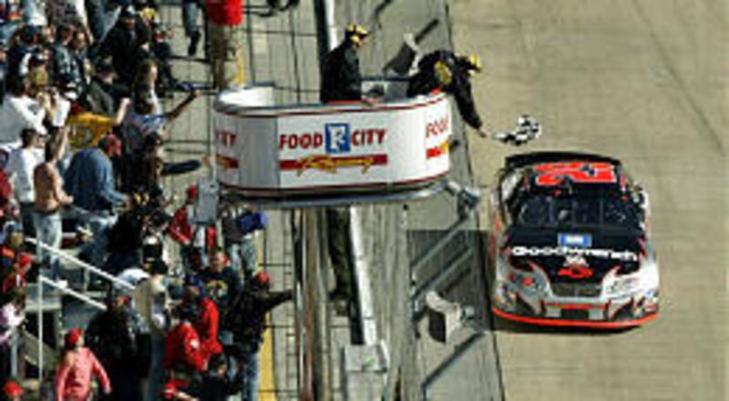 Kevin Harvick takes the checkered flag to win the NASCAR Food City 500 at the Bristol Motor Speedway on Sunday in Tennessee.