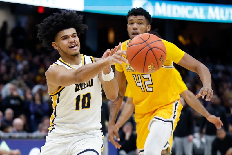 Toledo guard RayJ Dennis passes the ball against Kent State Saturday, March 11, 2023, in Cleveland.