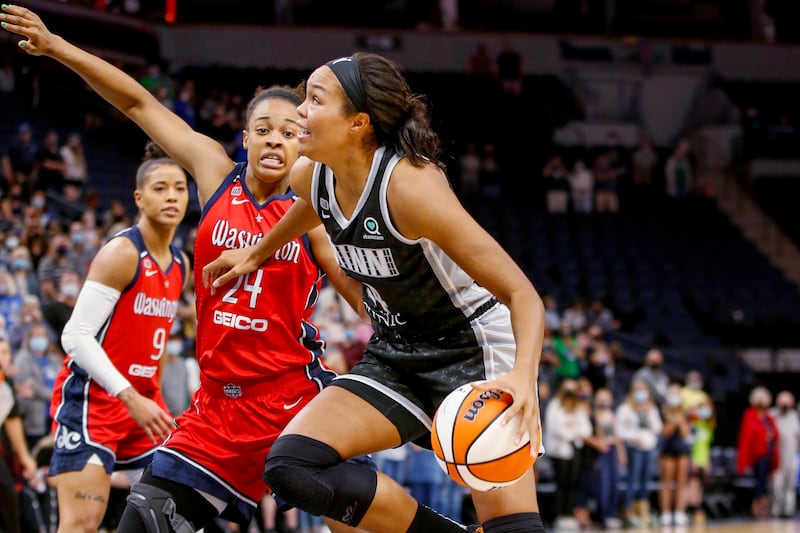 Washington Mystics forward Erica McCall defends against Minnesota Lynx forward Napheesa Collier, wearing blue.