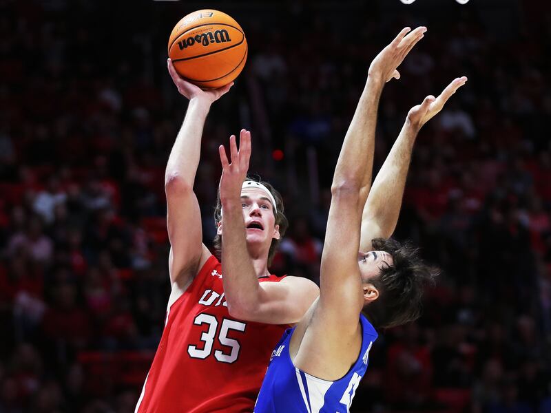 Utah Utes center Branden Carlson (35) goes up for a shot against Brigham Young Cougars forward Gavin Baxter.