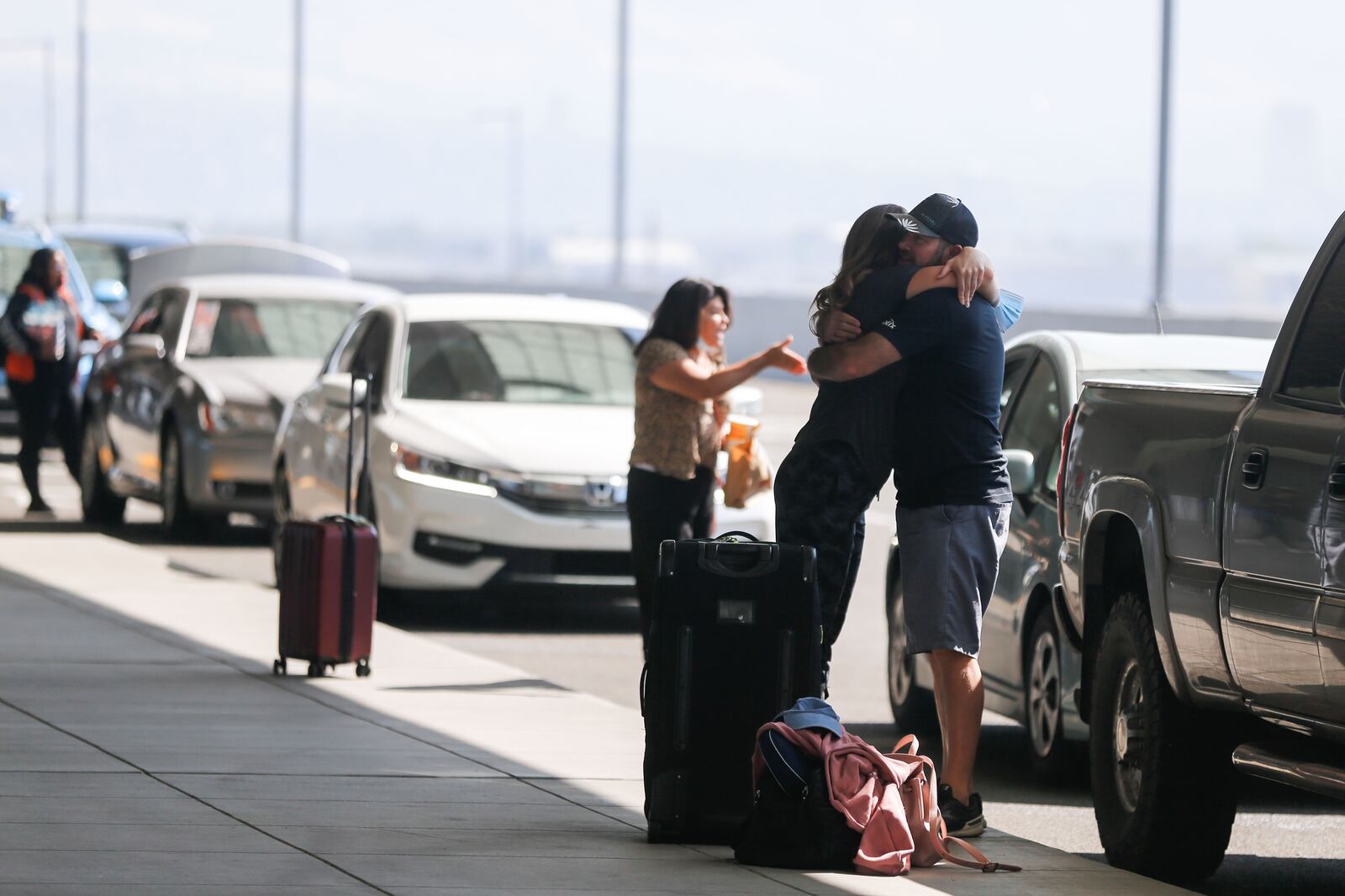 Anya Anderson, from Eden, embraces, her husband before departing for Russia outside of the Salt Lake airport.