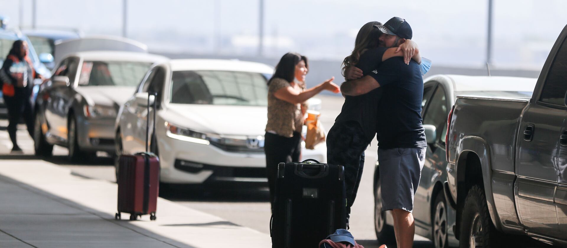Anya Anderson, from Eden, embraces, her husband before departing for Russia outside of the Salt Lake airport.