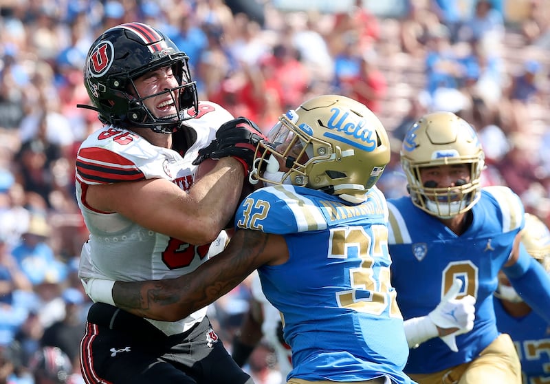 Utah Utes tight end Dalton Kincaid (86) gets tackled by UCLA Bruins defensive back William Nimmo Jr.