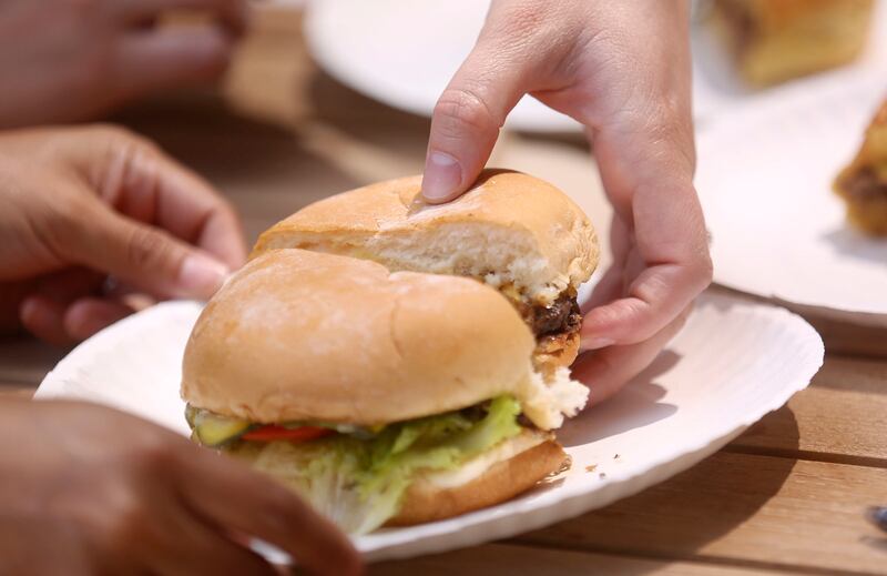 Taste testers pick up burgers to taste at the Deseret News office in the Triad Center in Salt Lake City on Tuesday, Aug. 6, 2019.