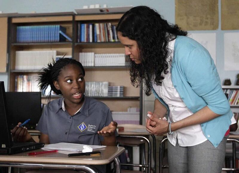 Student Mariatou Samou, left, speaks with her teacher, Kayla Morrow. Teacher preparation programs do not adequately prepare new teachers like Morrow for the rigors of the classroom, according to a new report from the National Coalition of Teacher Quality.