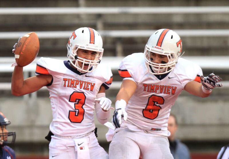 Timpview's Jordy Espinoza, left and Tristan Bradley celebrate after Espinoza's touchdown 4A semifinal high school football game against Woods Cross in the Rice-Eccles Stadium Friday, Nov. 14, 2014, Salt Lake City.