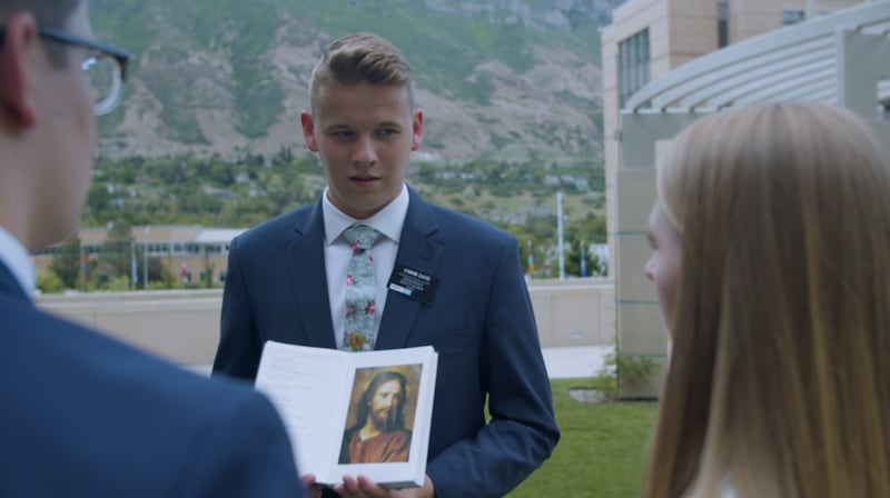 Elder Tyler Davis holds the Book of Mormon on the grounds of the Provo Missionary Training Center.