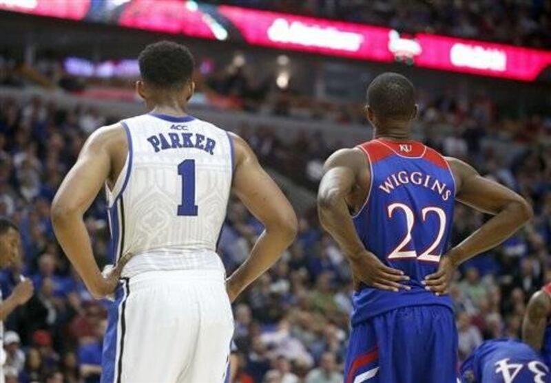 Duke forward Jabari Parker (1) and Kansas guard Andrew Wiggins (22) wait for a free throw during the second half of an NCAA college basketball game Tuesday, Nov. 12, 2013, in Chicago. Kansas won 94-83. (AP Photo/Charles Rex Arbogast)