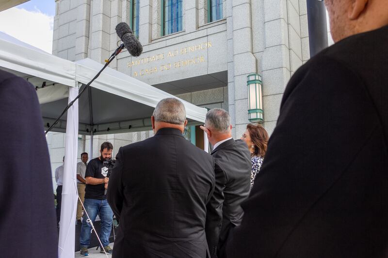 Elder Ulisses Soares shows an inscription on the front of the Rio de Janeiro Brazil Temple to Cardinal Orani Tempesta.