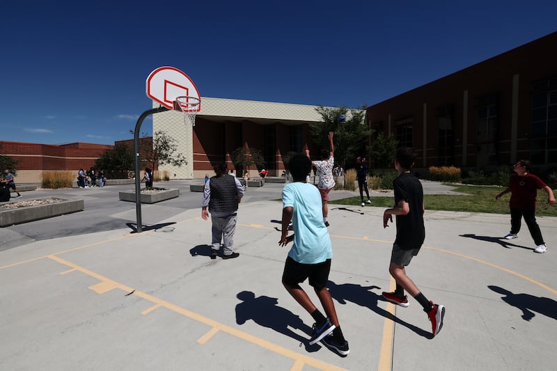 Students play basketball after lunch at Midvale Middle School.