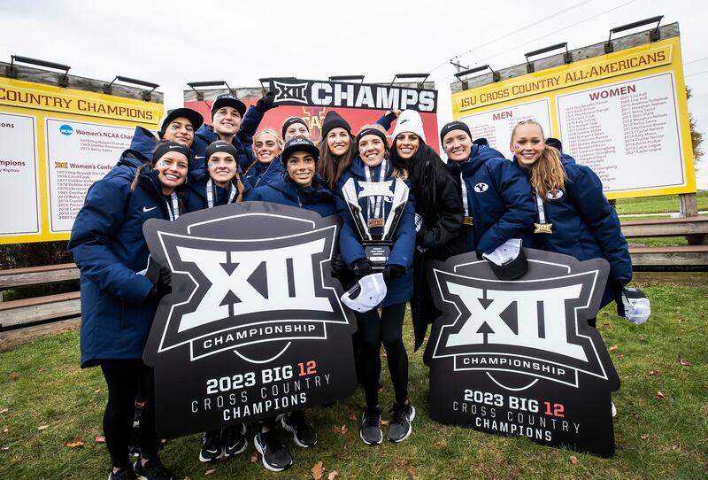 Members of the BYU women’s cross-country team celebrate their Big 12 cross-country championship Oct. 30, 2023.