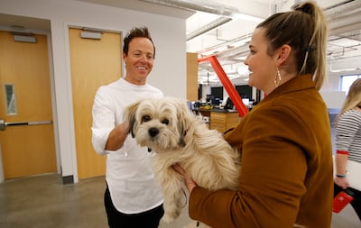 Qualtrics CEO Ryan Smith pets Kendall Gibson's dog Teddy in Provo on Feb. 2, 2018. Qualtrics is a global leader in the realm of customer experience analytics and was acquired Sunday for $8 billion.