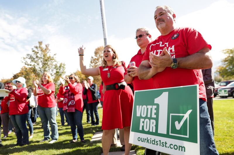 Roger Donohoe, a teacher from Cache County, right, and others gather for a day of canvassing at the Utah Education Association office in Murray on Oct. 13, 2018.