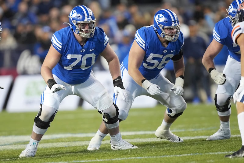 BYU offensive linemen Connor Pay (70) and Clark Barrington block during game against Virginia, Oct. 30, 2021, in Provo.