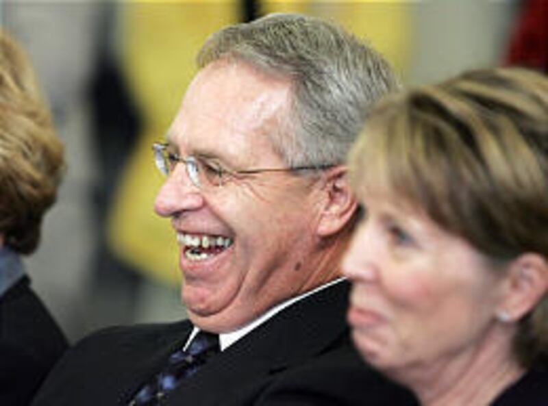 New Utah State University President Stan Albrecht, with assistant provost Sydney Peterson, is all smiles Tuesday at program announcing his advancement from provost.